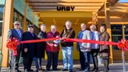 Officials from Urby and the Town of Harrison cut the ribbon on new 381-unit building at Harrison Urby. [From Left to Right] Jesus Huranga, Harrison 1st Ward Councilmember; Larry Bennett, Harrison 3rd Ward Councilmember; David Barry, Founder and CEO of Urby; James A. Fife, Mayor of Harrison; Richard Miller, CEO of The Pegasus Group; James Doran, Harrison 4th Ward Councilmember; Eleanor Villalta, Harrison 2nd Ward Councilmember; Ellen Mendoza, Harrison 2nd Ward Councilmember.